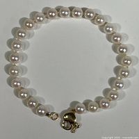 Full view of the pearl bracelet laid flat showing all pearls and the clasp