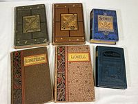 Six hardcover vintage poetry books arranged on white surface. Titles visible: Longfellow, Lowell, Scott, Whittier, Browning Arlington Edition, and Tennyson.