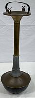 Full view of the vintage floor standing ashtray showing base, stem, and ashtray bowl with handle.
