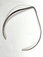 Top view of the vintage sterling silver choker necklace on a white background, showing the polished surface and open-ended design.