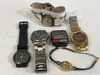 Group shot of six watches showing mixed analog and digital styles