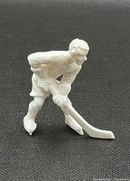 Front view of the white plastic hockey player figure showing detailed pose and features.