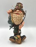 Front view of the hillbilly fisherman sculpture showing detailed fishing rod, hat with lures, fish catch and facial expression.