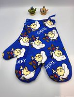 Blue Tetley Tea oven mitts with bear graphics featuring white lettering and repeated bear images.