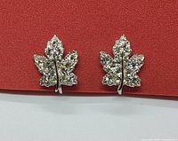 Front view of the maple leaf shaped earrings with clear rhinestones visible.