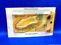 Front view of the vintage 3D Sudbury Basin mines model on card, showing the plastic basin shape, map, and mineral samples.
