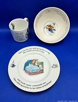 Top view of the plate, bowl, and mug showing Peter Rabbit illustrations and story text on each item.