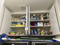 Cabinets with microfiber cloths, cleaning solution bottles, mesh bags, mounting squares, and chair protectors inside.