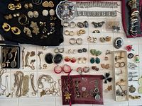 Overhead view of assorted costume jewelry laid out on trays