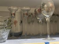 Shelf display showing ten wine glasses, two cordials, one water pitcher, and four scalloped dessert bowls