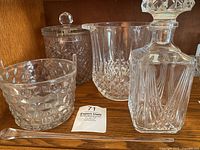 Full lot arranged on wooden shelf with all items visible including ice buckets, decanter, ice pick and lid.