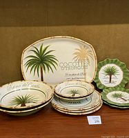 Overview of certified international Palm Island pattern tableware including oval serving platter and round plates.
