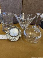 Lot showing all items including crystal clock, bowls, candlesticks, and glassware on display surface.