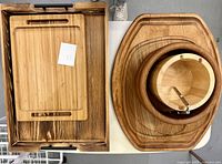 Overview of all wooden kitchen items showing trays, bowls, and utensils including nutcracker.