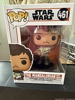 Front view of Funko Pop Star Wars The Mandalorian with Grogu figure inside original packaging showing box art, number 461, and figure details.