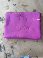 Top view of hot pink memory foam laptop or iPad case with visible foam indentations and a small 'InCase' logo tag on the side.