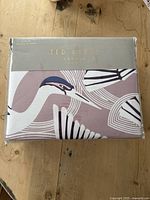 Front view of the packaged Ted Baker bedding set showing crane design and brand name Ted Baker London on label.