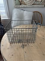 Front and side view of the vintage gray metal wire fryer basket showing grid design, rectangular shape, and hooks attached for hanging.