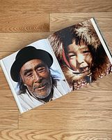 Open pages showing a portrait of an elderly man and a smiling child wearing traditional winter clothing