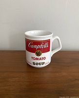 Front view of the Campbell's Tomato Soup ceramic mug showing the detailed soup label design.
