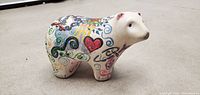 Hand-painted porcelain bear figurine with colorful patterns