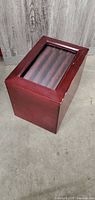 Closed wooden file box with glass top showing reddish mahogany finish, cube shaped at about 5x5x5 inches.