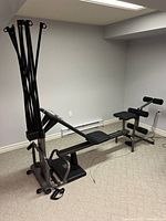 Main unit partially assembled showing power rod tower, base frame, bench seat and leg extension attachment