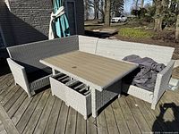 Full view of corner bench, long bench, table, and stools assembled on deck