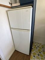 Front view of a white compact refrigerator with upper freezer door closed, showing the Toast-r brand logo.