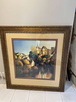Full view of framed print showing the entire artwork and the wide gold frame with some surface wear.