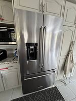 Front exterior view of stainless steel refrigerator with French doors and freezer drawer