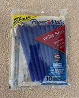 Clear plastic package containing 10 blue Paper Mate Write Bros. ballpoint pens, with the package intact and product label visible.