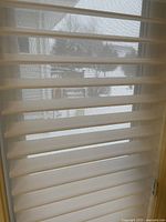 Hunter Douglas Silhouette blind partially open showing fabric vanes and sheer mesh that allows light through while maintaining privacy.