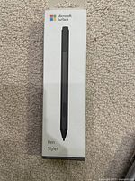 Front of the Microsoft Surface Pen box showing an image of the black pen stylus and branding.