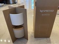 Nespresso Barista Collection stackable serving set in original cardboard packaging showing two serving cups.