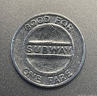 Front side of the token showing 'GOOD FOR ONE FARE SUBWAY' text and central subway label.