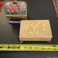 Two jewelry boxes displayed side by side with measuring tape showing length approximately 10 inches for the alabaster box.