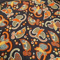 Full view of the scarf showing the bird and floral design on dark background.