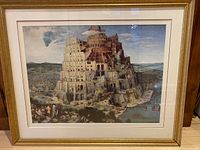 Full front view of framed Dieter Brugels' Tower of Babel print showing the architectural details of the tower and surrounding landscape under glass.