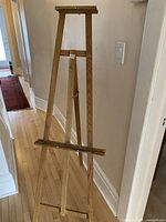 View of the easel fully assembled and standing, showing its height and structure.
