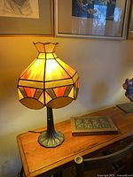 Angled view of lamp on table showing full shade and base