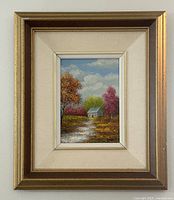 Framed oil on board painting showing full front view with a cottage scene in autumn colors and multi-layered gold frame.