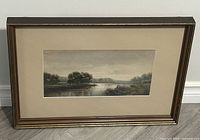 Full view of framed watercolour painting showing the river landscape and figures fishing by the bank.
