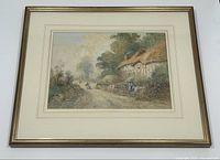 Framed watercolour painting hanging on white wall showing full artwork and frame