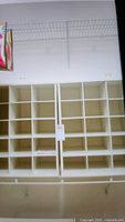 Two wooden shoe storage shelf units each with 15 cubbyholes for shoe organization