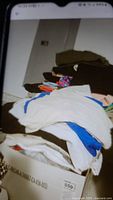 Photo showing a boxed pile of assorted women's shorts in various colors and fabrics, some folded and some stacked.