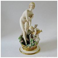Front view of full figurine on round gilt-trimmed base