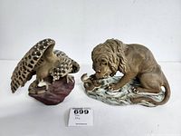 Image showing both lion and hawk sculptures together depicting a battle with a snake, highlighting size and detailing.