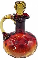 Front and side view of amberina glass cruet showing gradient color and handle