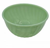 Photo of the Fire-King Jadeite mixing bowl showing its fluted exterior and glossy finish.